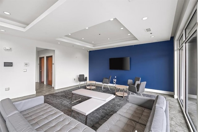 living room featuring a raised ceiling