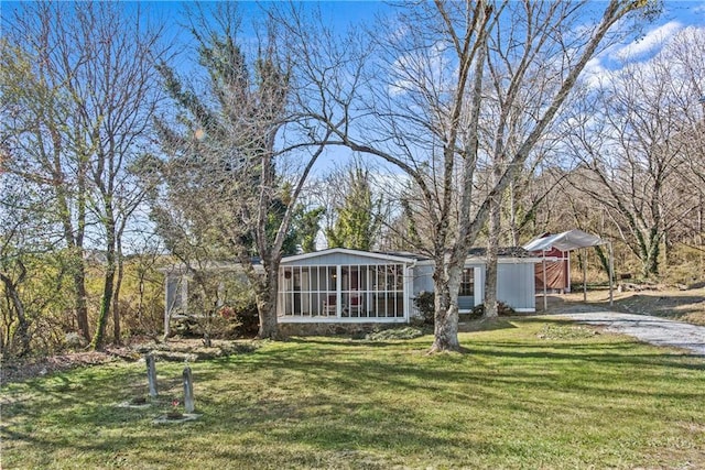 view of yard with a sunroom and an outdoor structure