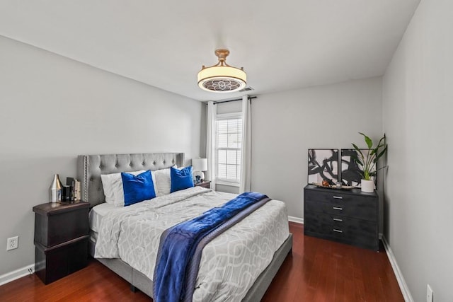 bedroom with dark hardwood / wood-style flooring