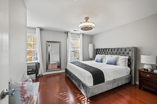 bedroom with dark hardwood / wood-style floors