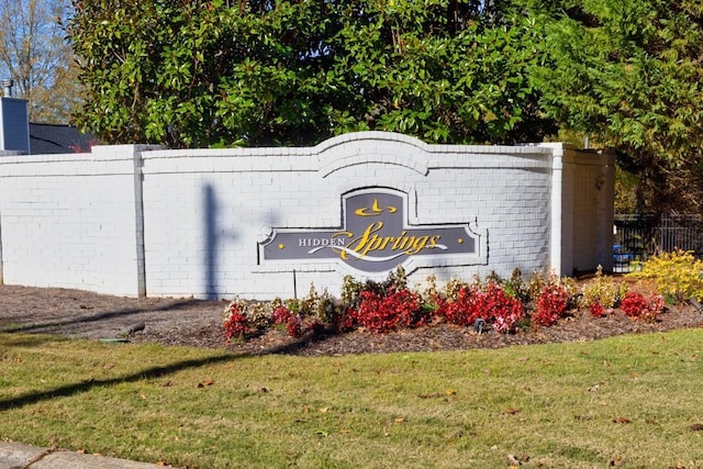 community / neighborhood sign featuring a yard