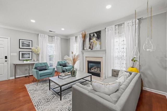 living room with hardwood / wood-style flooring and ornamental molding