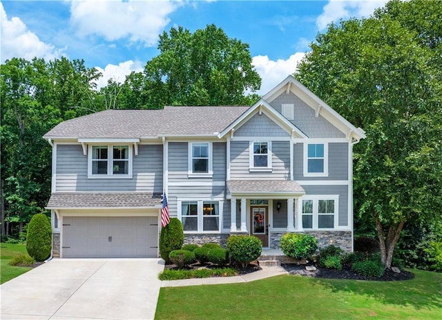 craftsman inspired home with a front yard and a garage