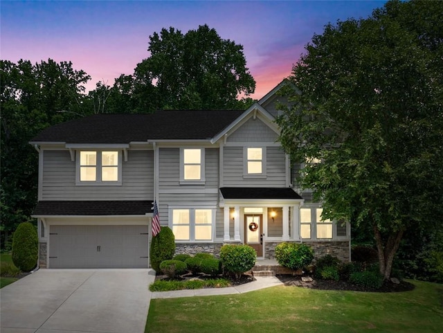 view of front of property with a lawn and a garage