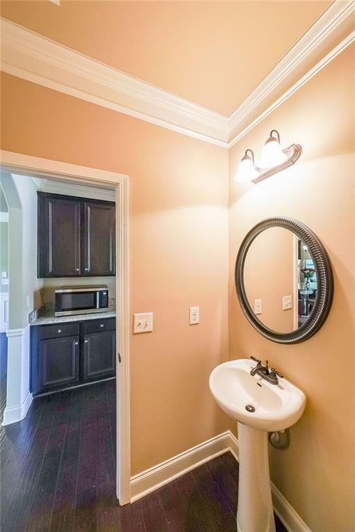 bathroom featuring ornamental molding and hardwood / wood-style floors