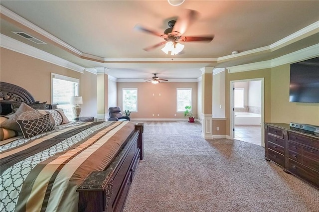 bedroom with a tray ceiling, decorative columns, visible vents, carpet flooring, and baseboards