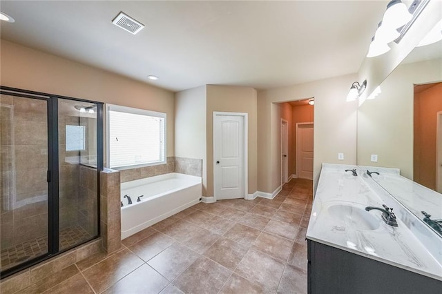 bathroom featuring double vanity, visible vents, a bath, a shower stall, and a sink