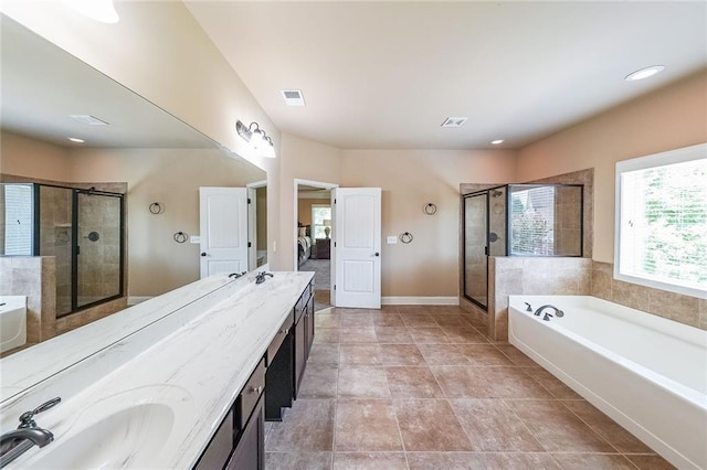 full bathroom with double vanity, a stall shower, visible vents, a garden tub, and a sink