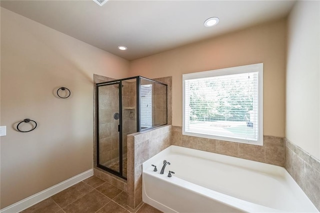 bathroom featuring tile patterned floors and separate shower and tub