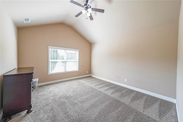 additional living space featuring lofted ceiling, a ceiling fan, visible vents, baseboards, and carpet