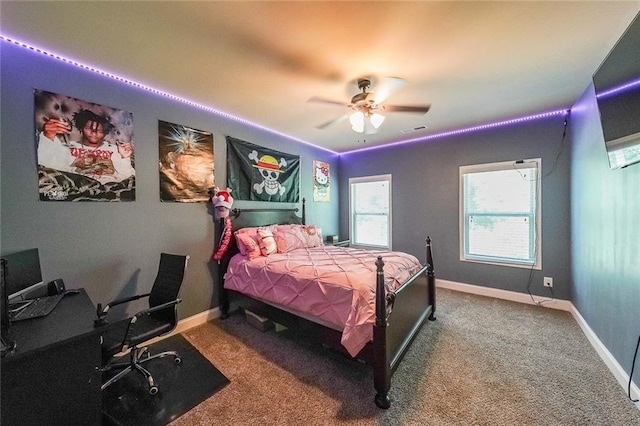 carpeted bedroom with a ceiling fan, visible vents, and baseboards