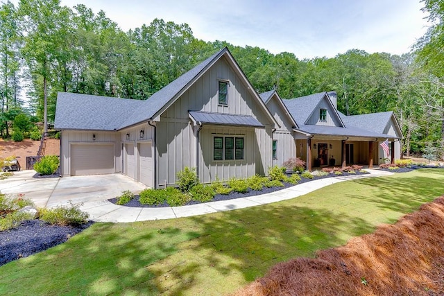 1889 Jefferson River Rd, Jefferson, GA 30549 - modern farmhouse featuring concrete driveway, a front lawn, a garage, and roof with shingles