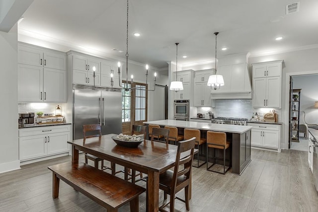 1889 Jefferson River Rd, Jefferson, GA 30549 - dining room featuring ornamental molding, light wood-type flooring, recessed lighting, and a barn door