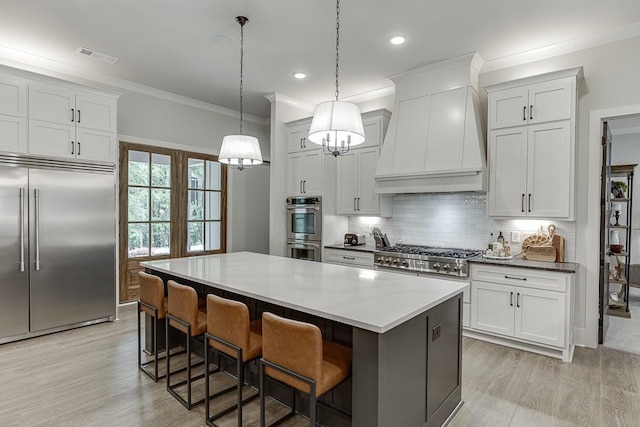 1889 Jefferson River Rd, Jefferson, GA 30549 - kitchen with appliances with stainless steel finishes, custom exhaust hood, crown molding, a kitchen island, and light wood-style floors