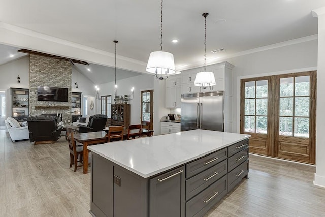 1889 Jefferson River Rd, Jefferson, GA 30549 - kitchen featuring stainless steel built in fridge, light wood-type flooring, white cabinets, a center island, and lofted ceiling