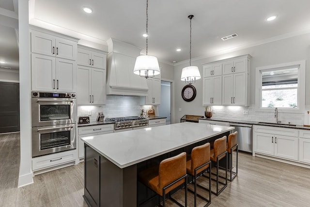 1889 Jefferson River Rd, Jefferson, GA 30549 - kitchen with appliances with stainless steel finishes, ornamental molding, tasteful backsplash, a center island, and a breakfast bar area