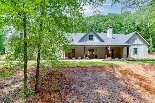 1889 Jefferson River Rd, Jefferson, GA 30549 - view of front of house featuring board and batten siding, a chimney, french doors, and roof with shingles