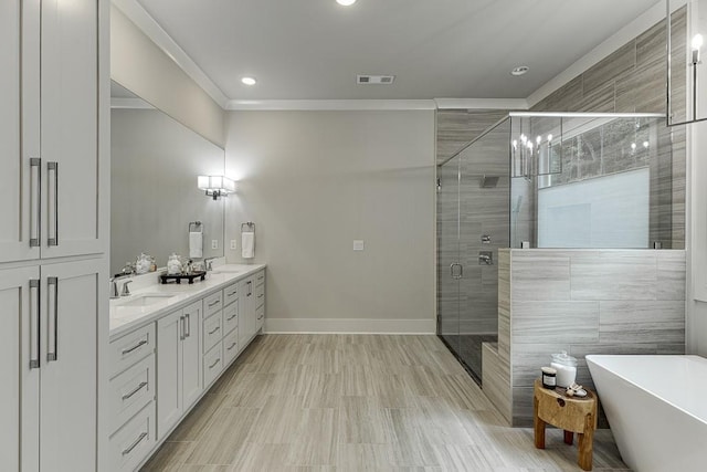 1889 Jefferson River Rd, Jefferson, GA 30549 - full bath featuring double vanity, a stall shower, a freestanding tub, ornamental molding, and recessed lighting