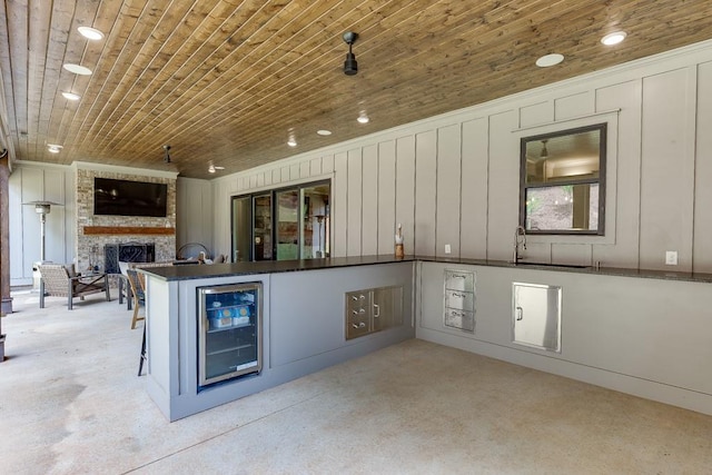 1889 Jefferson River Rd, Jefferson, GA 30549 - kitchen with beverage cooler, dark countertops, a fireplace, wood ceiling, and a peninsula