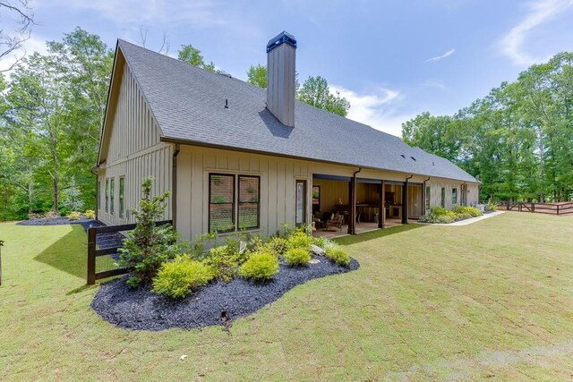 1889 Jefferson River Rd, Jefferson, GA 30549 - back of property with a chimney, a shingled roof, a patio, and board and batten siding