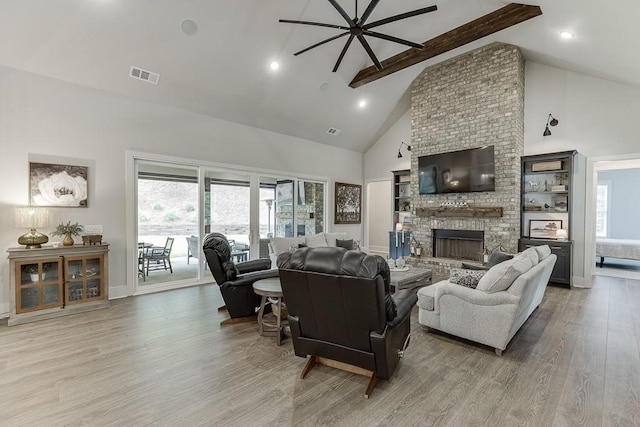 1889 Jefferson River Rd, Jefferson, GA 30549 - living area featuring high vaulted ceiling, a ceiling fan, beamed ceiling, light wood finished floors, and a brick fireplace