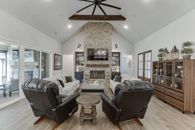 1889 Jefferson River Rd, Jefferson, GA 30549 - living room featuring high vaulted ceiling, light wood-type flooring, a fireplace, beam ceiling, and a ceiling fan