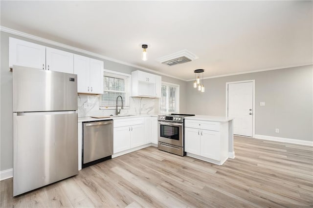 2198 Star Mist Dr SW, Atlanta, GA 30311 - kitchen featuring stainless steel appliances, crown molding, a peninsula, white cabinets, and light countertops