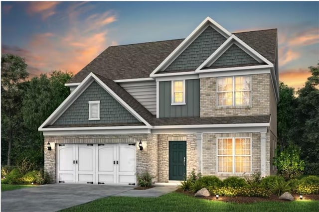 craftsman-style home with board and batten siding, an attached garage, roof with shingles, and driveway