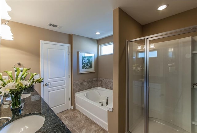 full bath featuring visible vents, double vanity, a stall shower, a sink, and a bath