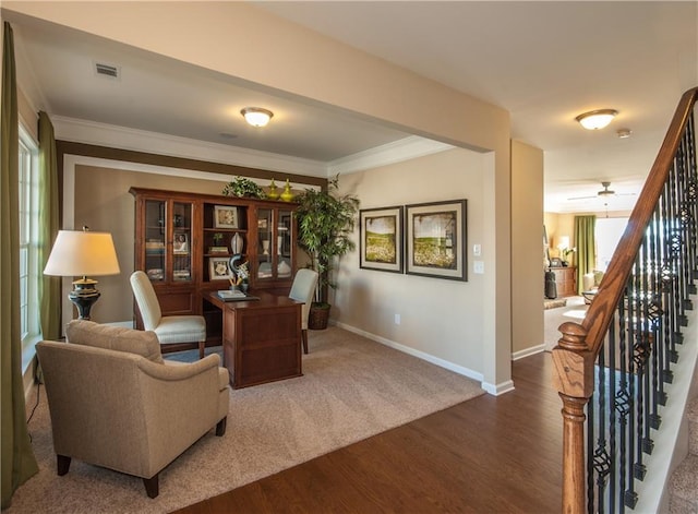 home office featuring crown molding, wood finished floors, visible vents, and baseboards