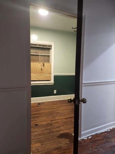 interior space featuring baseboards and wood finished floors