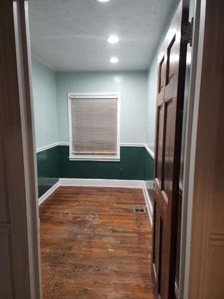 unfurnished room featuring baseboards, visible vents, recessed lighting, and wood finished floors