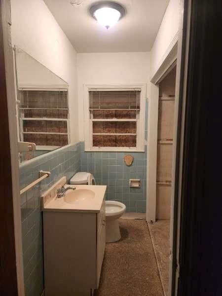 bathroom featuring tile walls, toilet, and vanity