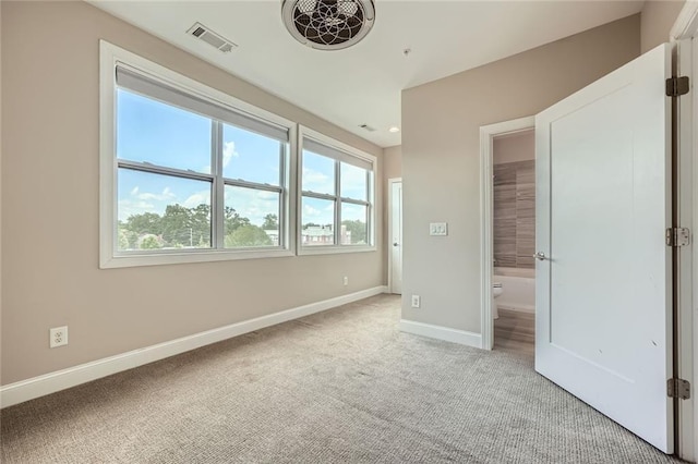 504 E Howard Ave, Decatur, GA 30030 - unfurnished bedroom featuring light colored carpet and ensuite bath