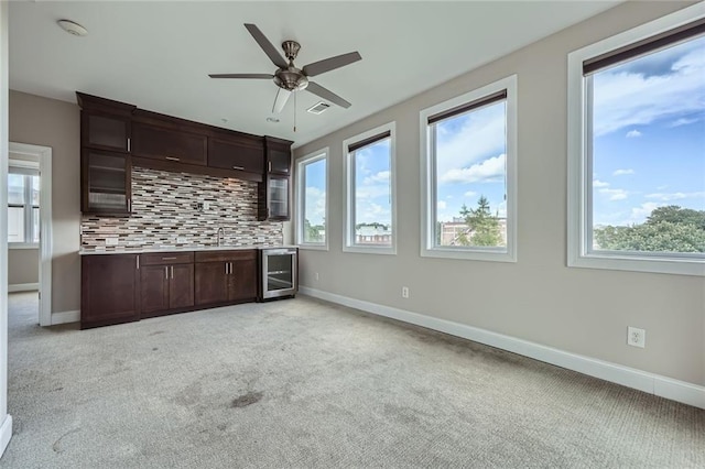 504 E Howard Ave, Decatur, GA 30030 - bar with decorative backsplash, plenty of natural light, wine cooler, and light carpet