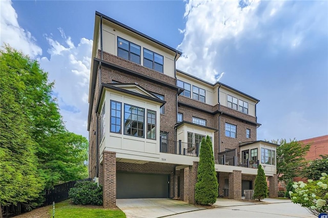 504 E Howard Ave, Decatur, GA 30030 - view of front facade with brick siding, an attached garage, and concrete driveway