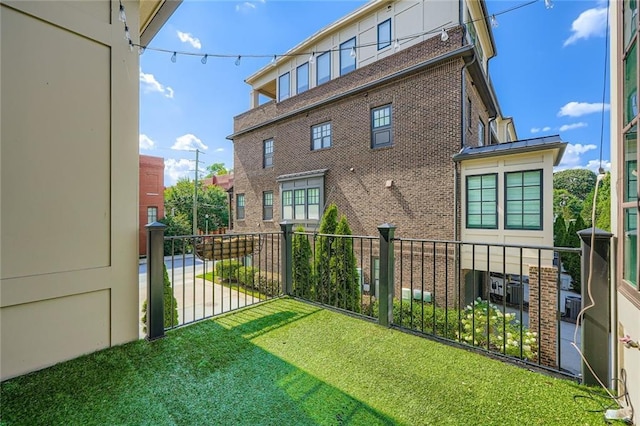 504 E Howard Ave, Decatur, GA 30030 - rear view of property featuring a balcony, brick siding, and a yard
