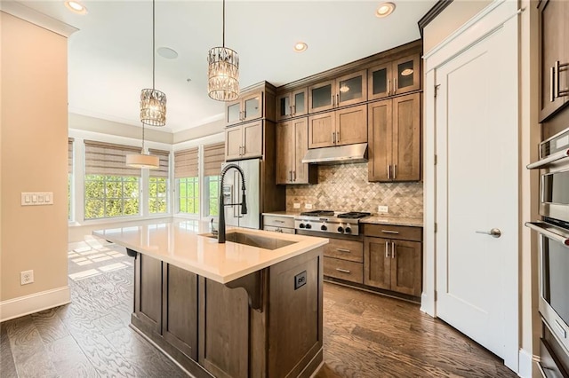 504 E Howard Ave, Decatur, GA 30030 - kitchen with under cabinet range hood, appliances with stainless steel finishes, recessed lighting, decorative backsplash, and light countertops