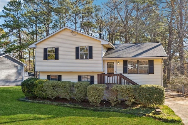 split level home featuring a front lawn