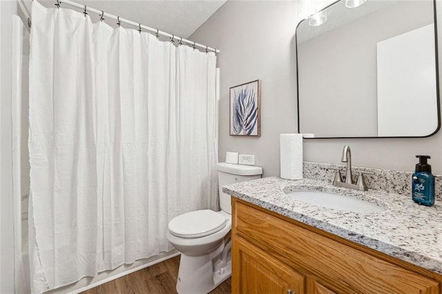 bathroom with vanity, hardwood / wood-style floors, curtained shower, and toilet