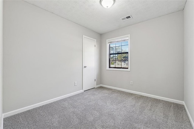 empty room featuring carpet floors and a textured ceiling