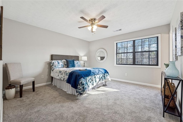 bedroom featuring a textured ceiling, carpet floors, and ceiling fan