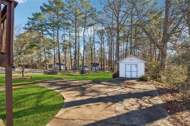 view of home's community featuring a lawn and a storage unit