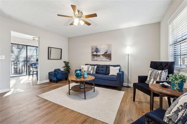 living room with hardwood / wood-style flooring and ceiling fan