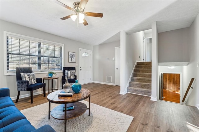 living room featuring hardwood / wood-style flooring and ceiling fan