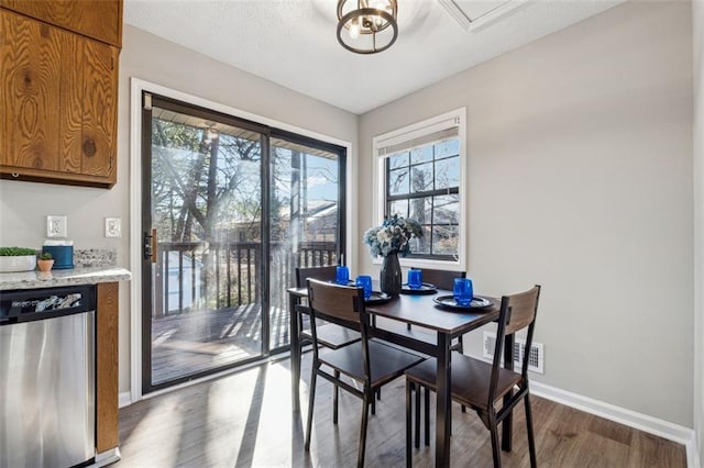 dining area with dark wood-type flooring and a textured ceiling