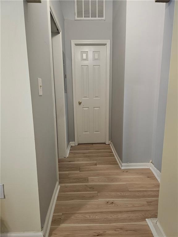 corridor with light hardwood / wood-style flooring