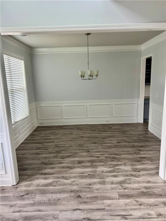 4416 Birch Meadow Trl, Gainesville, GA 30504 - unfurnished dining area with a chandelier, wood finished floors, crown molding, a decorative wall, and wainscoting