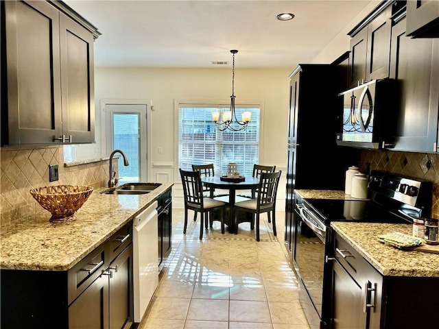 kitchen featuring light tile patterned floors, range with electric cooktop, stainless steel microwave, white dishwasher, and a sink