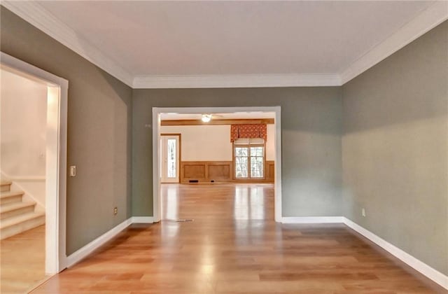 unfurnished room with ornamental molding and light hardwood / wood-style floors